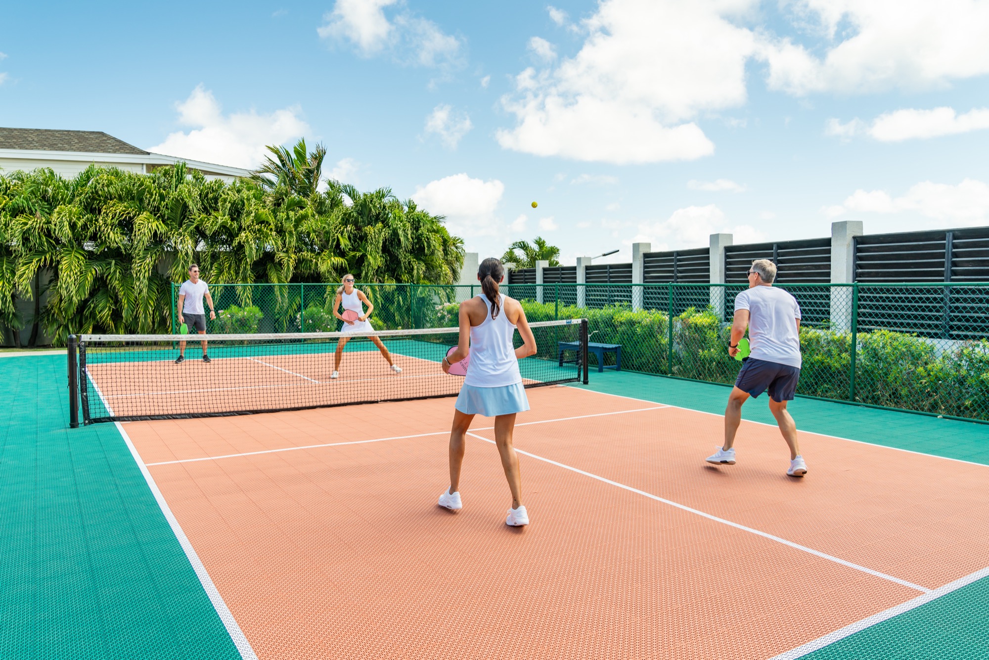Guests playing pickleball with ocean view
